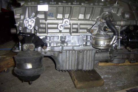 1997 Ford Taurus - Close-up view of an engine block a fuel pump and associated plumbing.