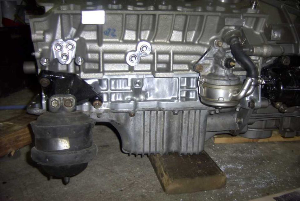Engine block with fuel pump and mounting bracket