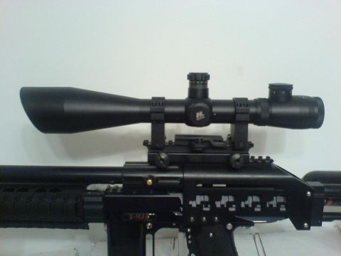1985 Ford Bronco - A close-up view of a rifle equipped with a telescopic sight, against a plain background.
