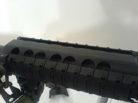 1985 Ford Bronco - Close-up view of a black rifle handguard a Picatinny rail system and ventilation slots.