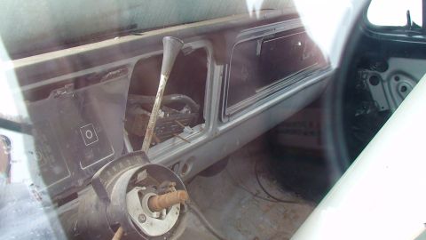 1979 Ford Bronco - Interior view of a 1979 Ford Bronco shows the dashboard, column shifter, and empty radio slot.