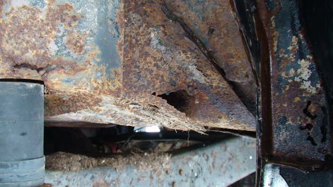 1979 Ford Bronco - Extensive rust damage on vehicle frame components, indicating significant deterioration.