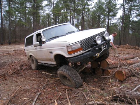 1996 Ford Bronco - 1996 Ford Bronco navigating an off-road obstacle course made of logs.