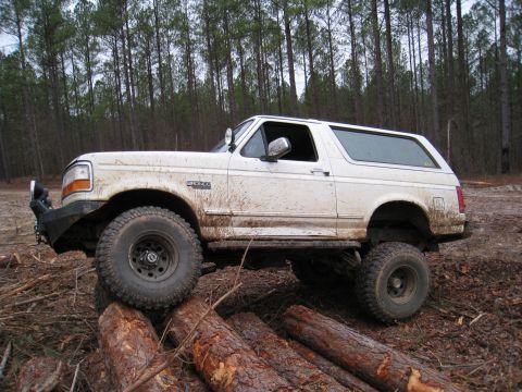 1996 Ford Bronco - This 1996 Ford Bronco is shown navigating a rough, wooded terrain with logs placed as obstacles.