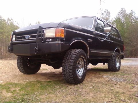 1990 Ford Bronco - This black Ford Bronco is equipped with large off-road tires and a heavy-duty front bumper.