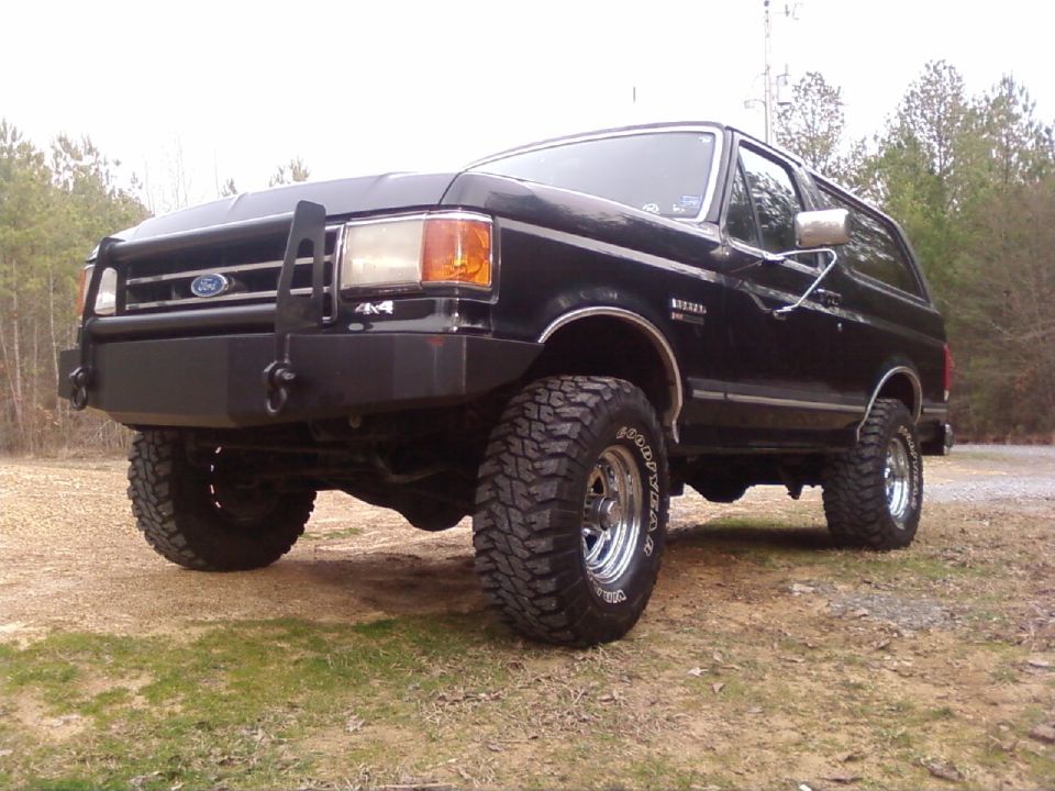 Black Ford Bronco with aftermarket bumper and large tires