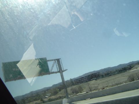 1989 Ford Bronco - View from a vehicle shows an overhead highway sign indicating Magic Mountain Parkway and route 170.