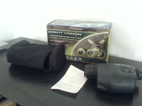 1985 Ford Bronco - Night vision monocular, its case, and original packaging are displayed on a table.
