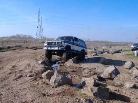 1986 Ford Bronco - This 1986 Ford Bronco tackles a challenging off-road course, demonstrating its capabilities.
