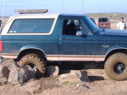 1986 Ford Bronco - This Ford Bronco is tackling a rocky obstacle course, showing off its off-road capabilities.