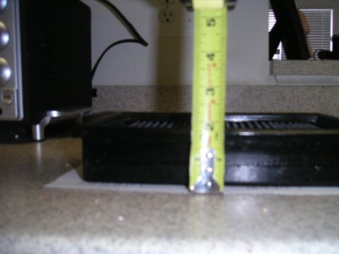 2002 BMW M3 - A yellow measuring tape is placed over a black air filter on a countertop.