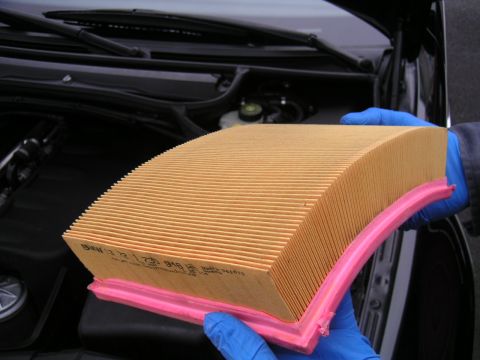 2002 BMW M3 - Close-up of a BMW air filter, part number 13721730916, being held for inspection.
