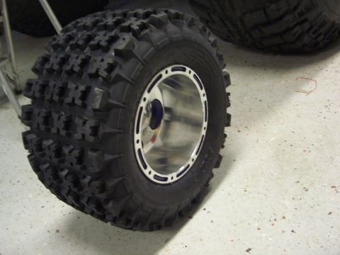 1974 Ford Bronco - A close-up view of an off-road tire and rim, a tread design suitable for challenging terrain.