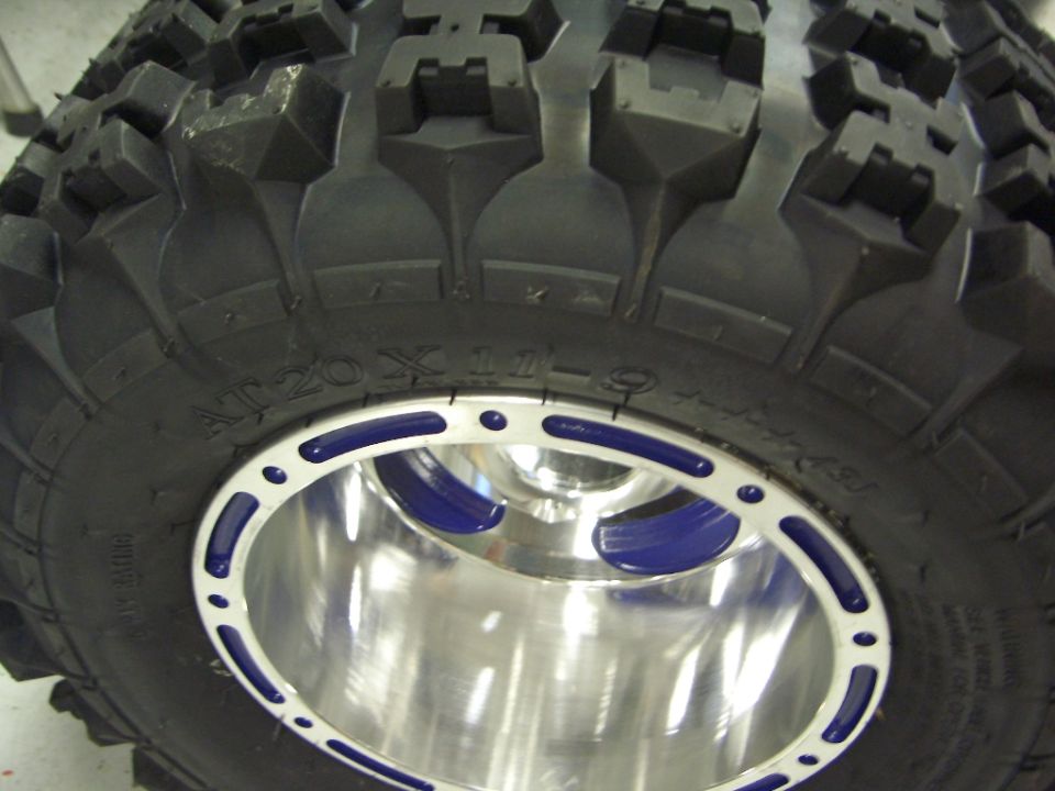 Close-up of an off-road tire with blue and silver custom wheel