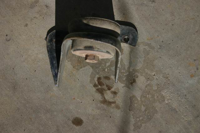 Suspension part with rubber isolator and metal bracket on concrete floor