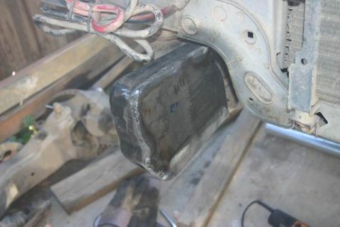 1991 Ford Bronco - Detail of vehicle front-end components, likely part of the radiator support structure.