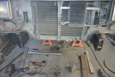 1991 Ford Bronco - The front end of a vehicle is shown disassembled, with its radiator and AC condenser exposed for repair or maintenance.