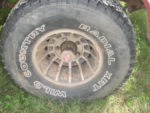 1989 Ford Bronco - Tire and wheel detail, showing 'COUNTRY WILD' and 'RADIAL XRT' lettering.