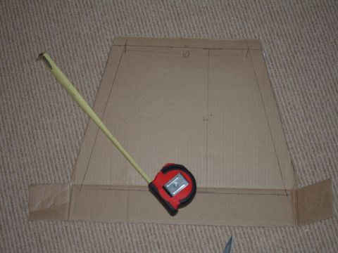 1998 BMW R1100GS ABS - Cardboard template with measurements and a tape measure on a carpeted surface.