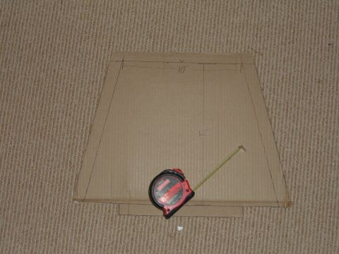 1998 BMW R1100GS ABS - A cardboard template is laid out on a carpeted surface with a tape measure on top.