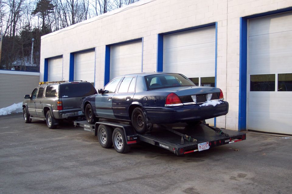 Rear view of a blue and gray 2001 Ford Crown Victoria on a trailer