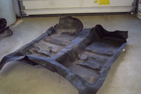 2001 Ford Crown Victoria - Car floor mats removed from vehicle, showing the underside and mounting points.