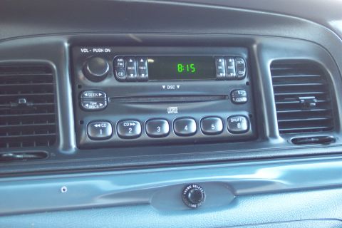 2001 Ford Crown Victoria - The interior of a 2001 Ford Crown Victoria displays its dashboard, including the radio and climate controls.