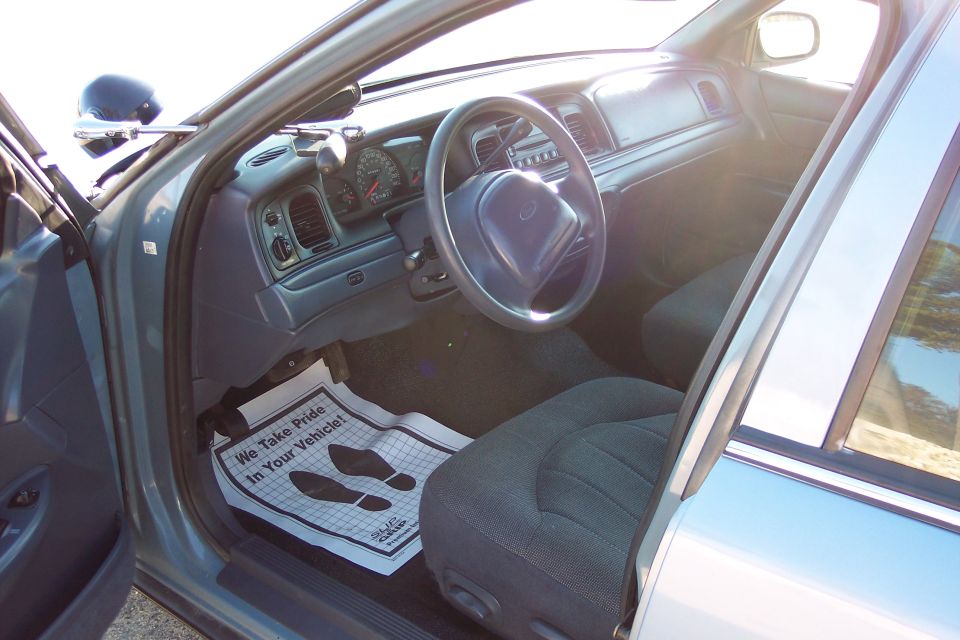 Interior of 2001 Ford Crown Victoria showing dashboard, steering wheel, and floor mat