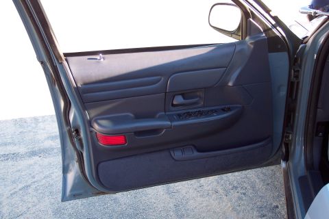 2001 Ford Crown Victoria - Interior view of the driver's side door panel on a 2001 Ford Crown Victoria.