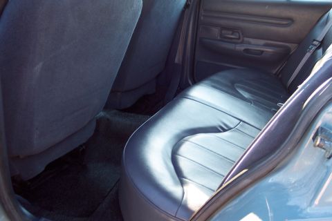 2001 Ford Crown Victoria - Interior view of the back seat and door panel of a vehicle.
