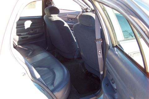 2001 Ford Crown Victoria - Rear interior view of a 2001 Ford Crown Victoria, highlighting the seats and door trim.