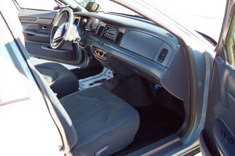 2001 Ford Crown Victoria - The interior of a 2001 Ford Crown Victoria, the dashboard, steering wheel, and front seats.