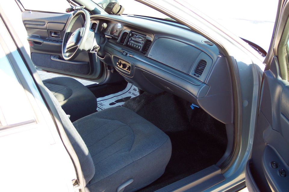 Interior of a 2001 Ford Crown Victoria, showing dashboard and front seats