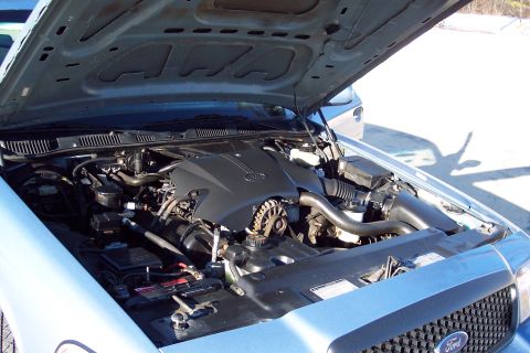 2001 Ford Crown Victoria - Engine bay of a 2001 Ford Crown Victoria, viewed from the front with the hood raised.