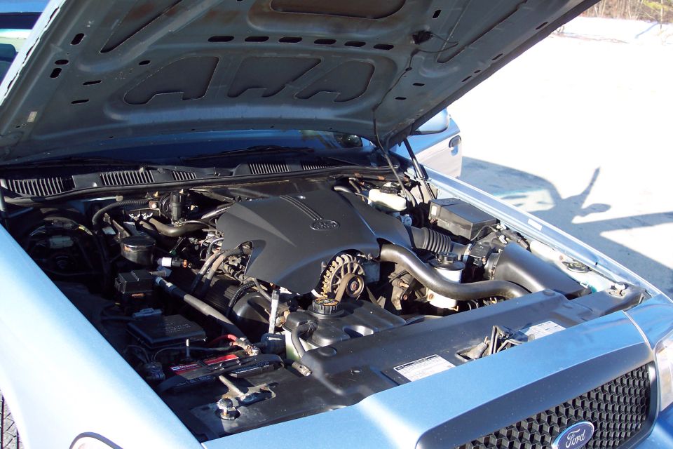 2001 Ford Crown Victoria engine bay with hood open, showing the V8 engine and battery