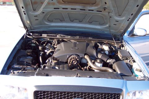 2001 Ford Crown Victoria - The engine compartment of a 2001 Ford Crown Victoria is open for inspection.