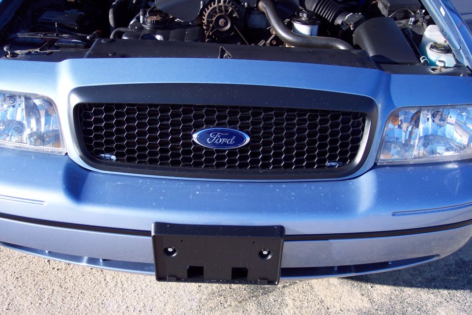 Blue 2001 Ford Crown Victoria front grille with Ford logo and headlights