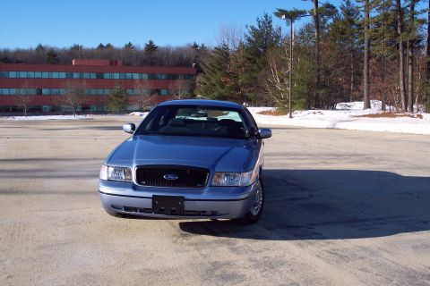 2001 Ford Crown Victoria - Front view of a blue 2001 Ford Crown Victoria in a parking lot during winter.