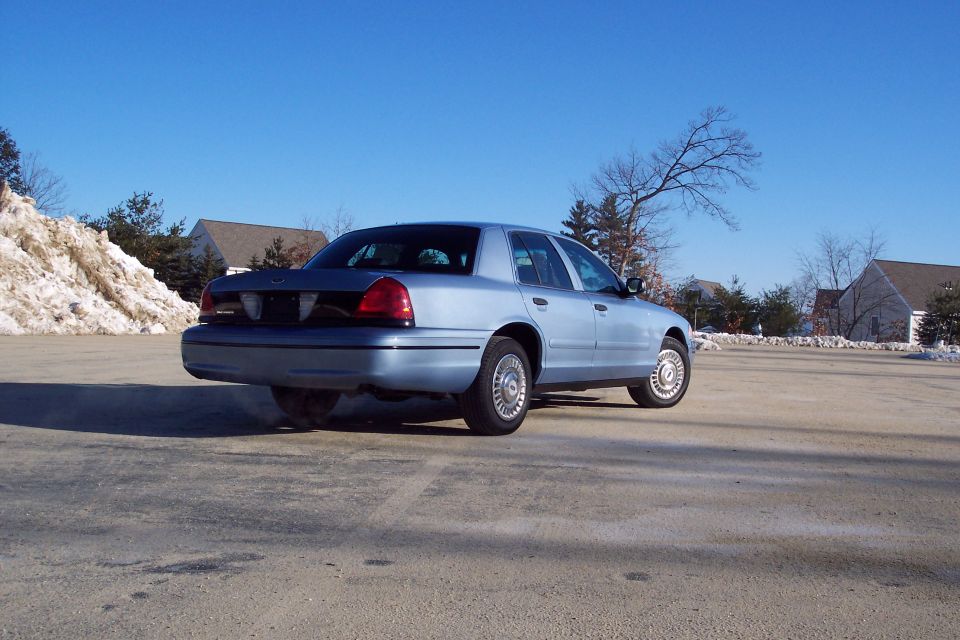 Light blue 2001 Ford Crown Victoria sedan, rear view