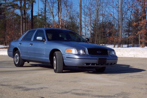 2001 Ford Crown Victoria - This 2001 Ford Crown Victoria sedan is shown from a 3q front angle, parked outdoors with trees and snow in the background.