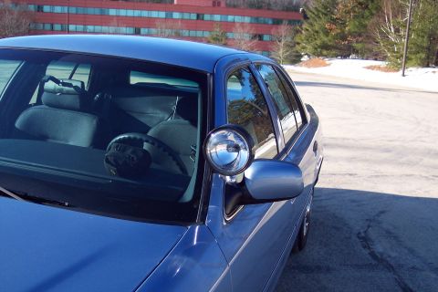 2001 Ford Crown Victoria - Front quarter view of a blue 2001 Ford Crown Victoria sedan equipped with a spotlight.