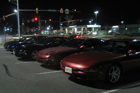 1993 Ford Probe - Several Ford Probes are parked in a lot at night, with a red one in the foreground.