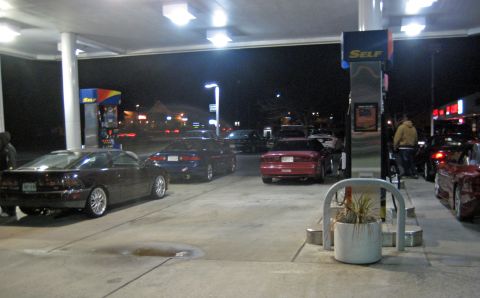 1993 Ford Probe - Cars gathered at a gas station during nighttime hours.