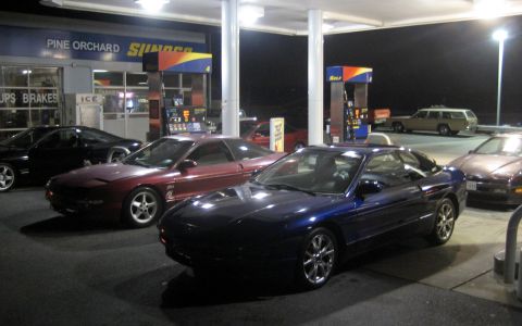 1993 Ford Probe - A blue 1993 Ford Probe is seen at a gas station alongside other vehicles.