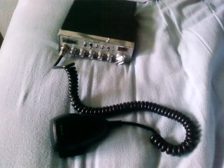 1995 Ford Bronco - A CB radio and its coiled microphone are shown on a white, textured surface.