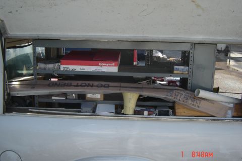 2006 Honda CBR-RR - Interior view of a truck bed with organized shelving containing various supplies and equipment.
