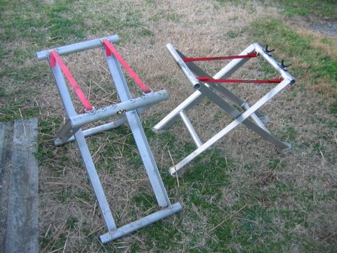 1992 Ford Mustang - Two aluminum stands with red straps are displayed on a grassy area.