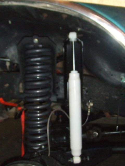 1996 Ford Bronco - Vehicle suspension components, including a coil spring and shock absorber, are visible in this close-up shot.