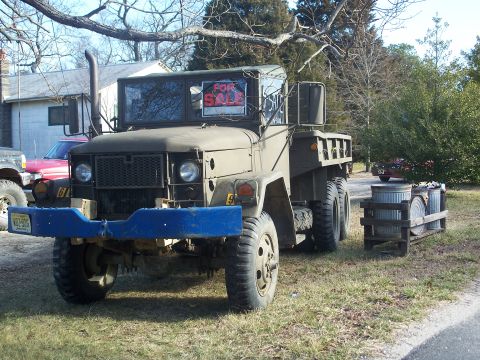 1979 Ford F-250 - A military truck is parked outside with a 'For Sale' sign in the windshield.