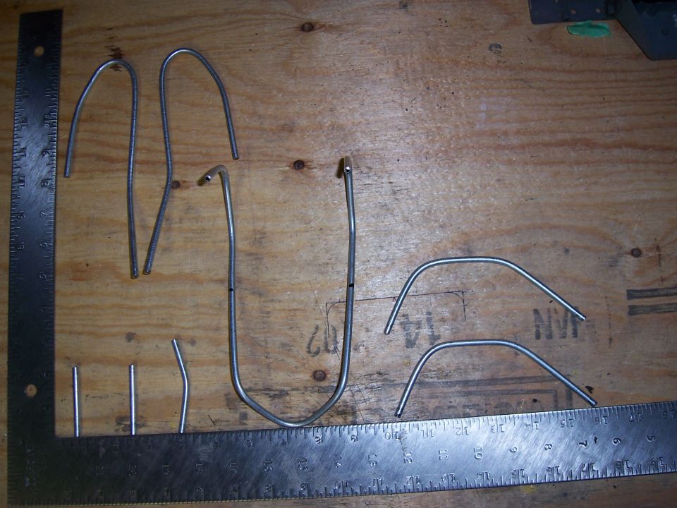 Metal tubes and rulers on a wooden surface